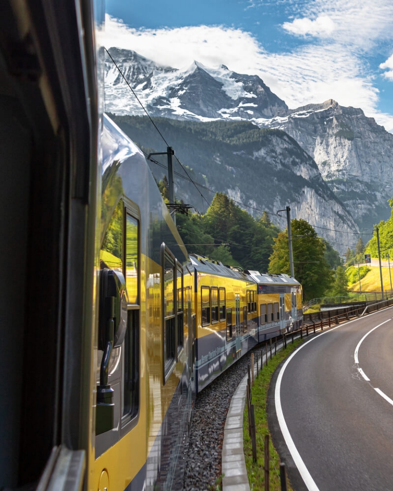 A train with mountains in the background