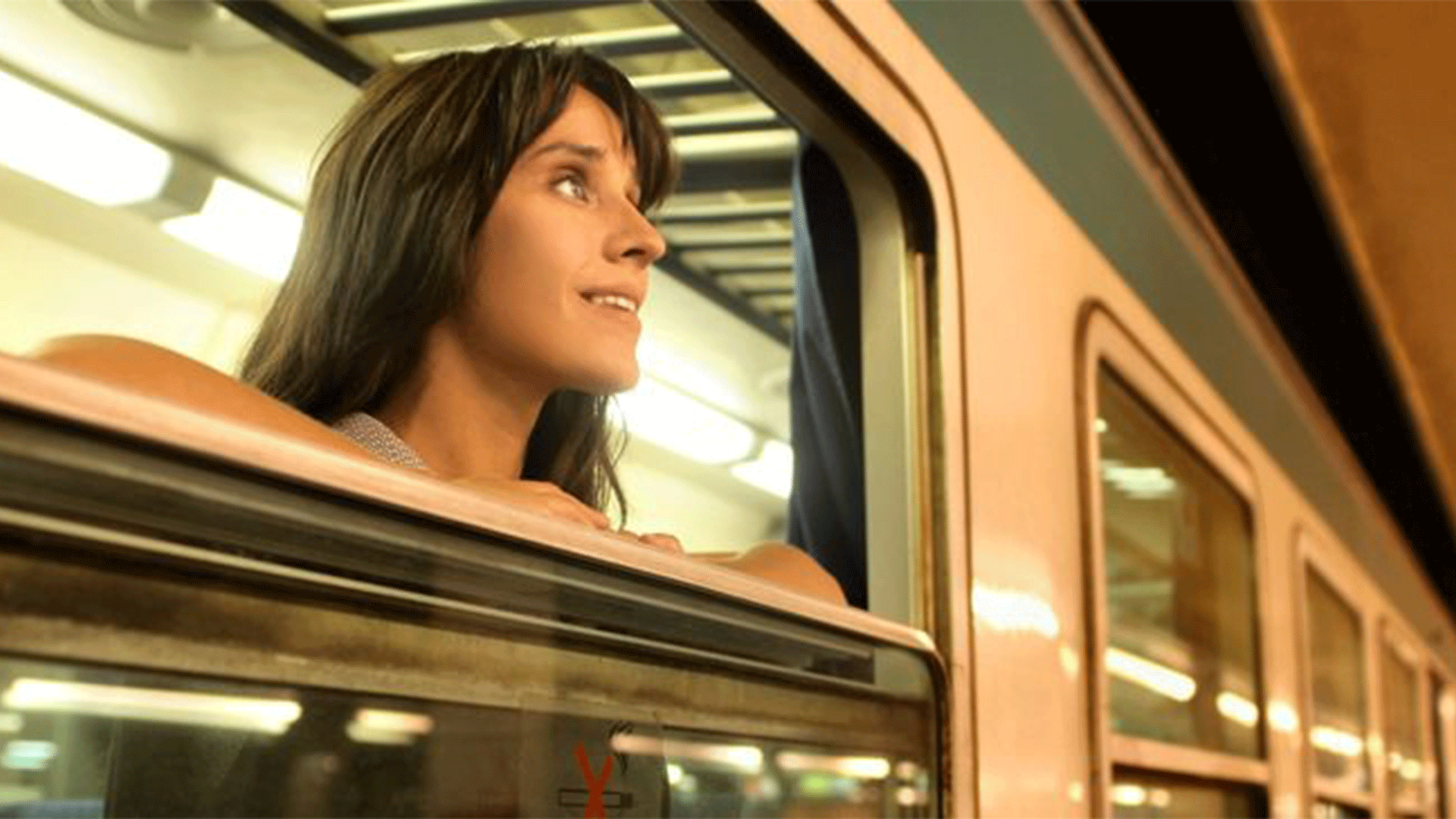 woman-looking-out-of-night-train