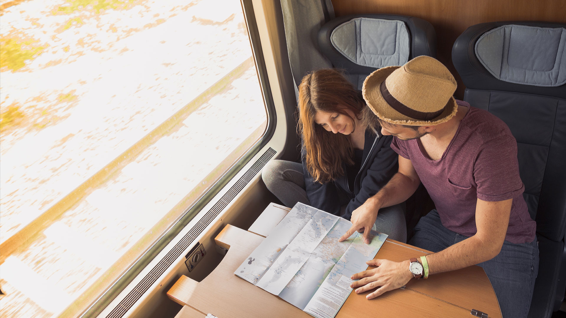 couple-travelling-on-train-next-destination