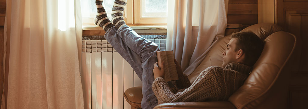 masthead-guy-reading-a-book-at-home