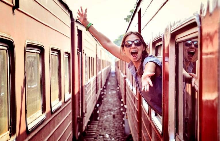 cheerful_woman_looking_out_the_window_of_the_old_train_edited