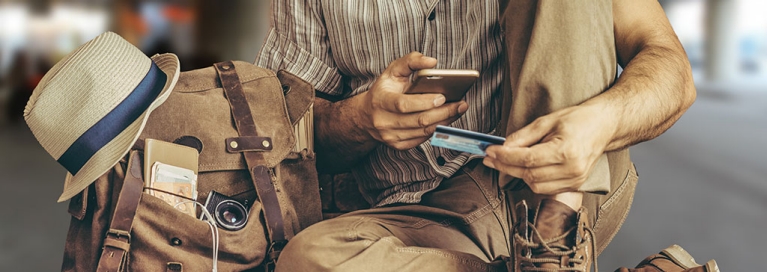 masthead-traveller-paying-something-on-phone-with-creditcard