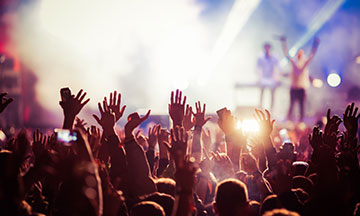 people-at-concert-hands-in-the-air