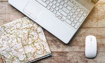 travel-planning-map-laptop-on-tabl