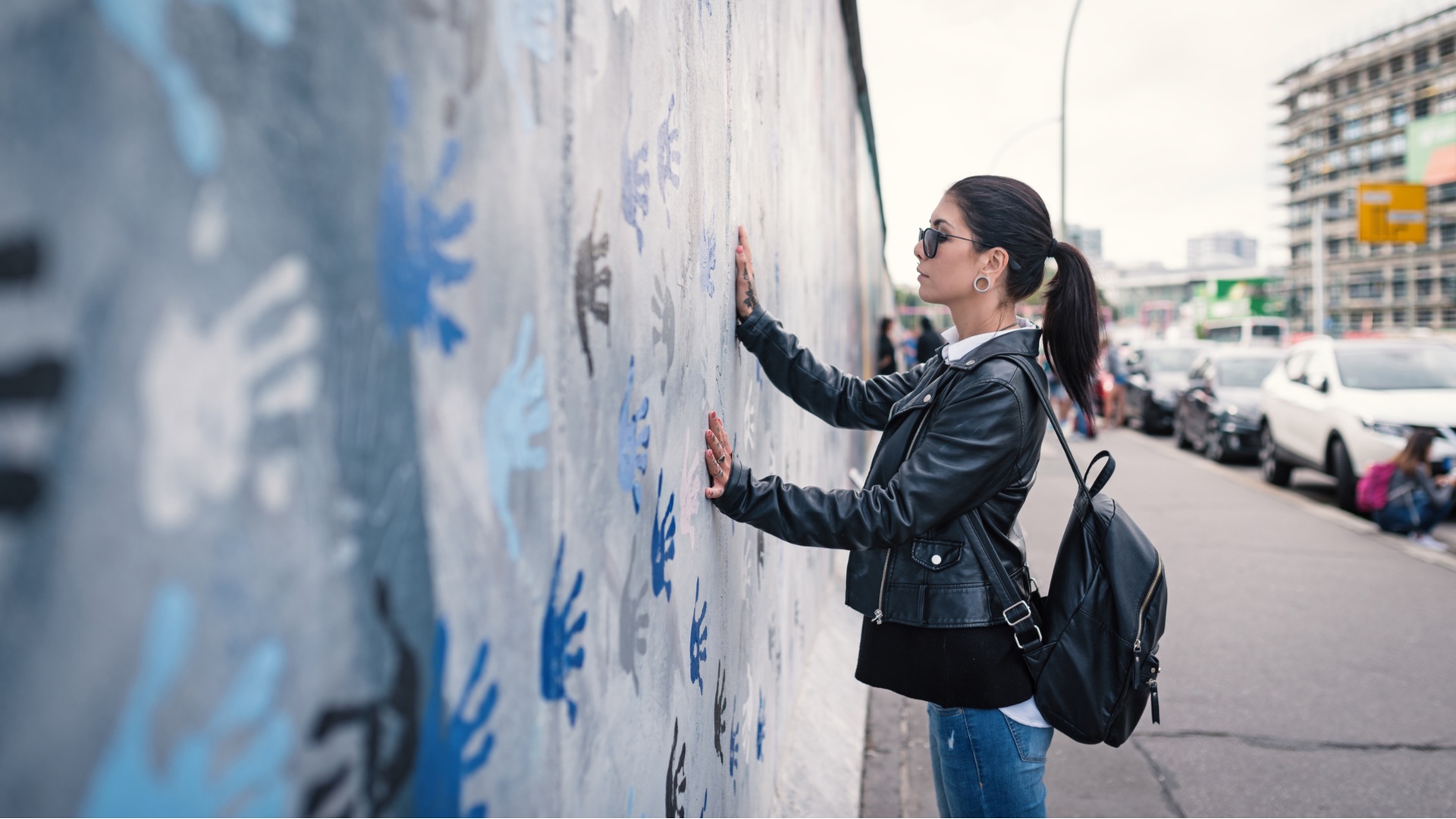 germany-berlin-wall-woman-touchig-it