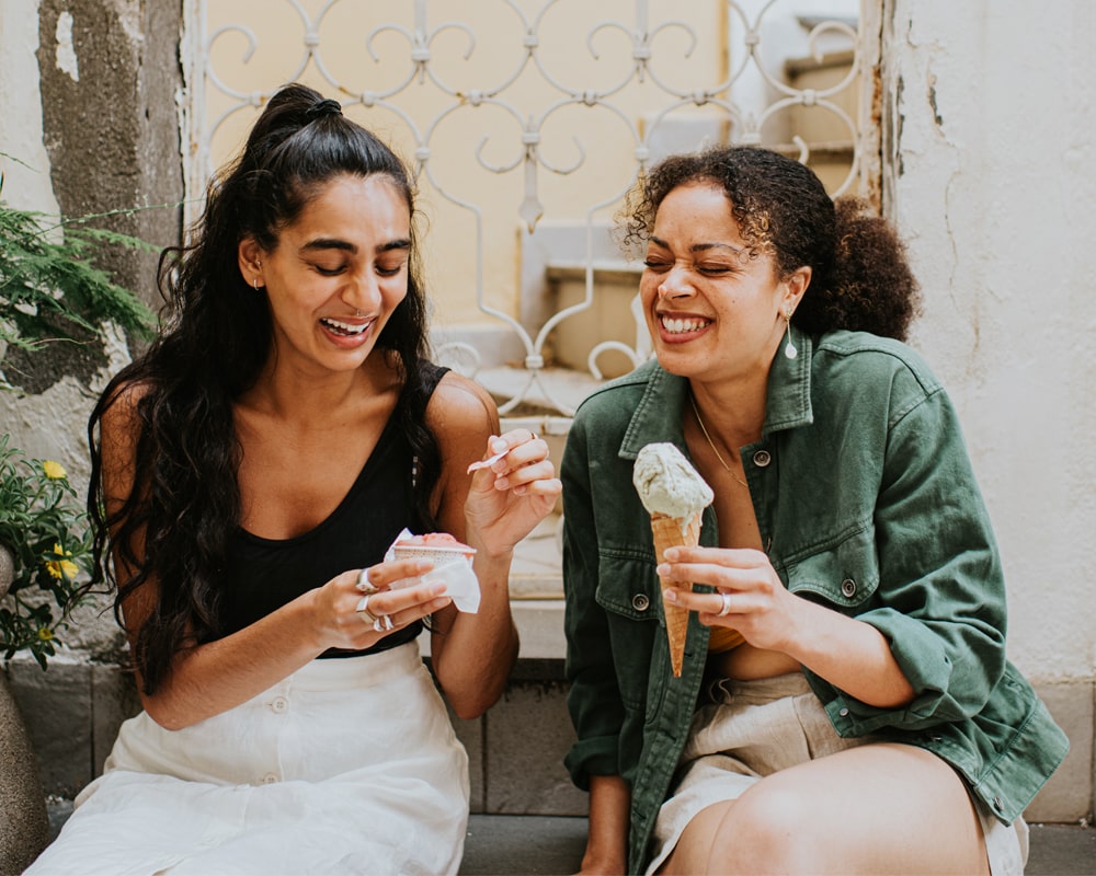Two women enjoying ice cream and having a good time