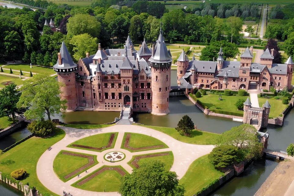 Aerial view of Kasteel de Haar, showcasing its towers, gardens, and surrounding landscape.