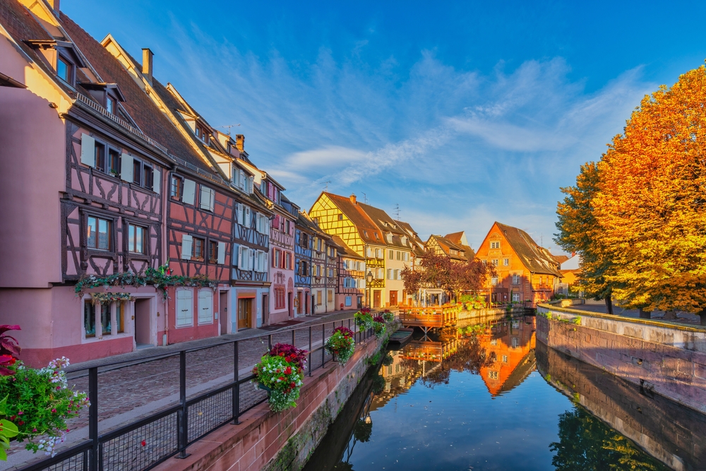 Colmar France, colorful half timber house city skyline at Ill River with autumn foliage season
