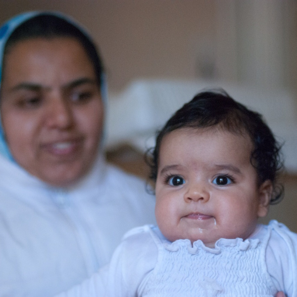 身穿 REFOOD 围裙的人拿着勺子和盘子的特写